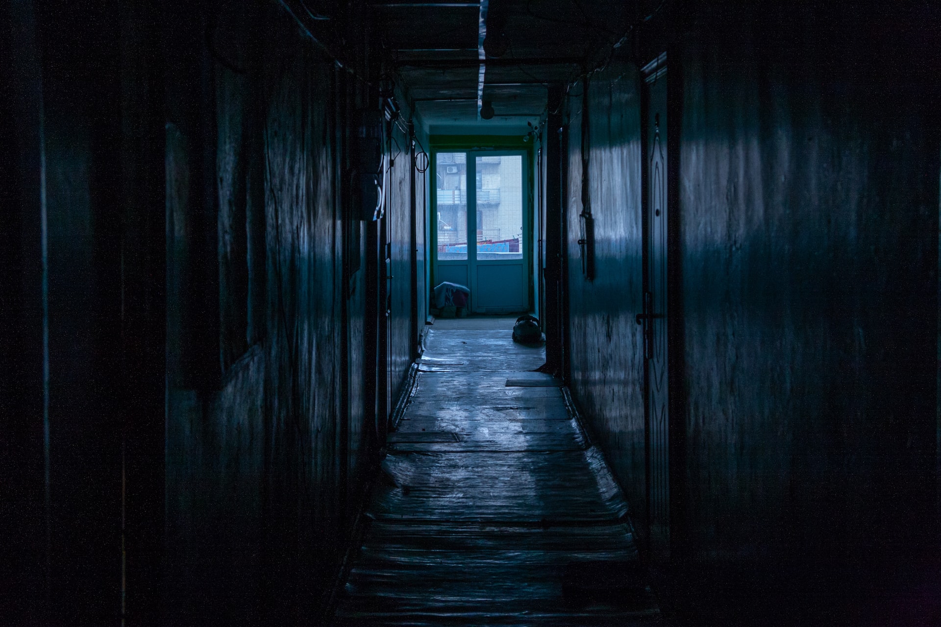 dark hallway in abandoned building black and white photo