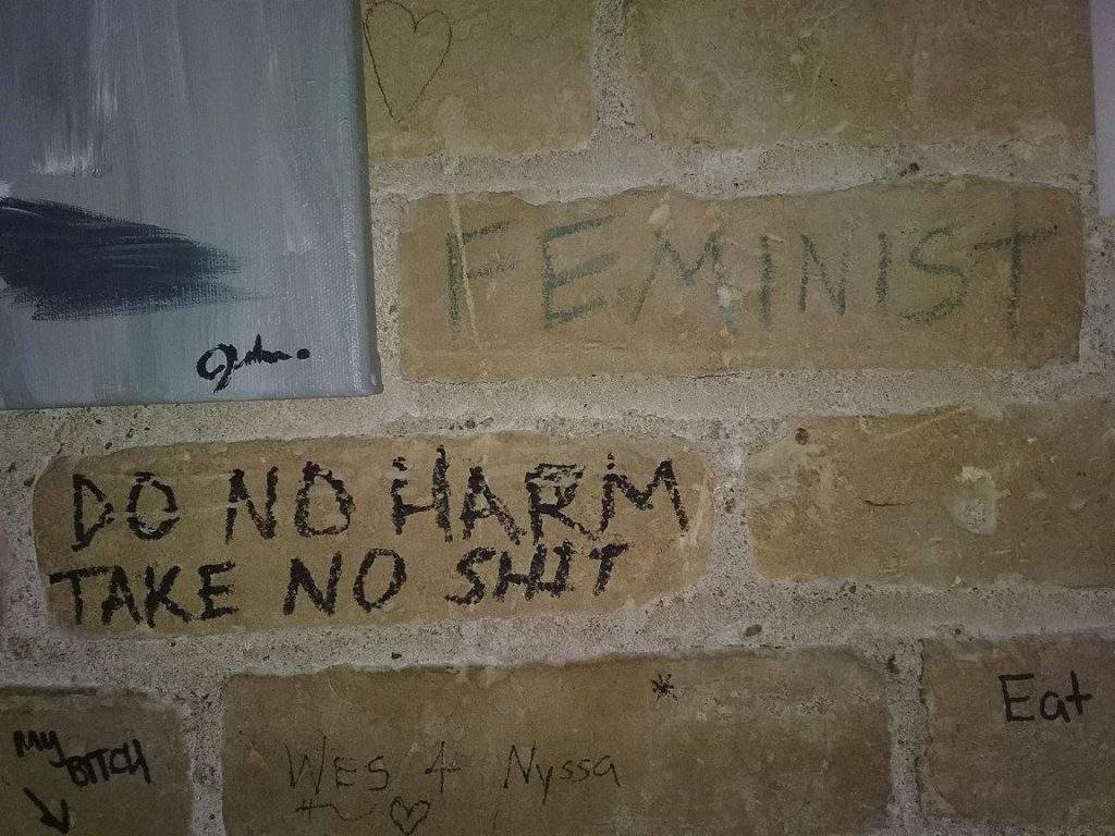 do no harm, take no shit on brick wall